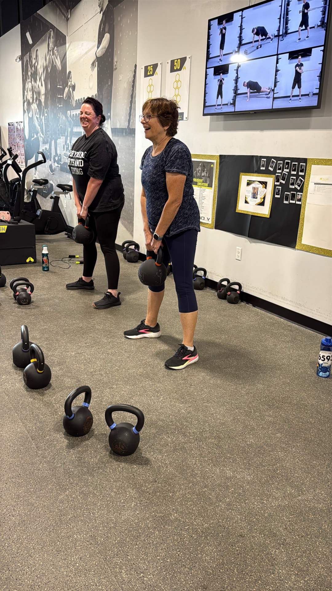 Two Mt. Juliet members smiling during kettlebell training